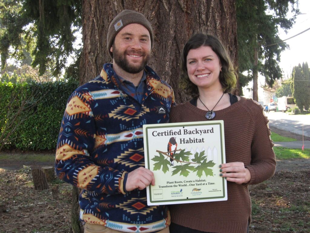Participants holding Certified Backyard Habitat sign.